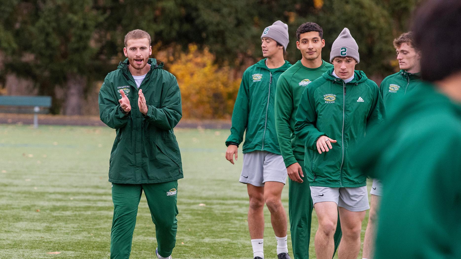 Owen Brady '25 cheering on Skidmore men's soccer players at practice. 